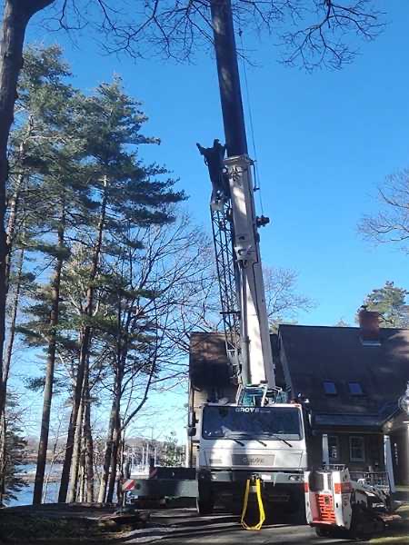 Timber Falls crane positioned beside a Kittery residence
