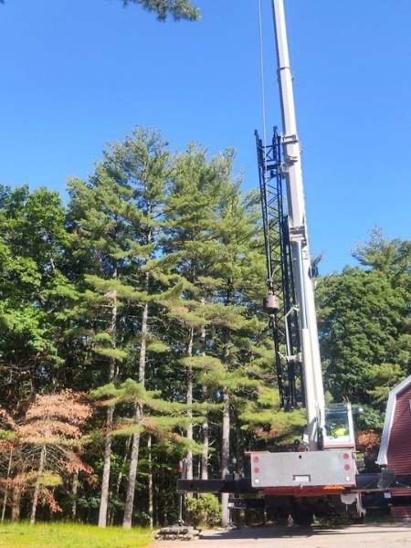 Large crane staged at a documented Timber Falls project in Rochester, New Hampshire