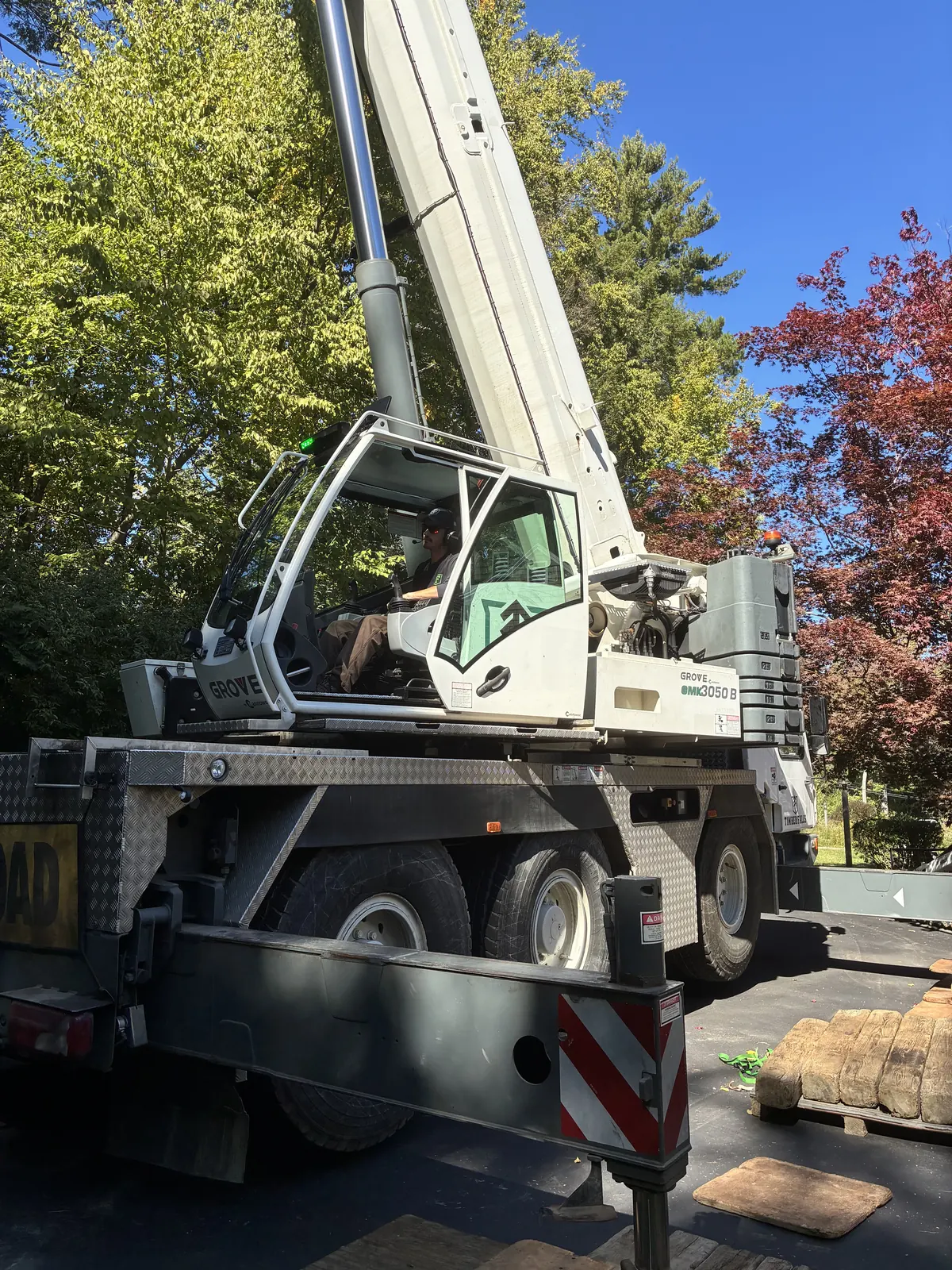 Timber Falls crane operator seated at the controls of the crane cab