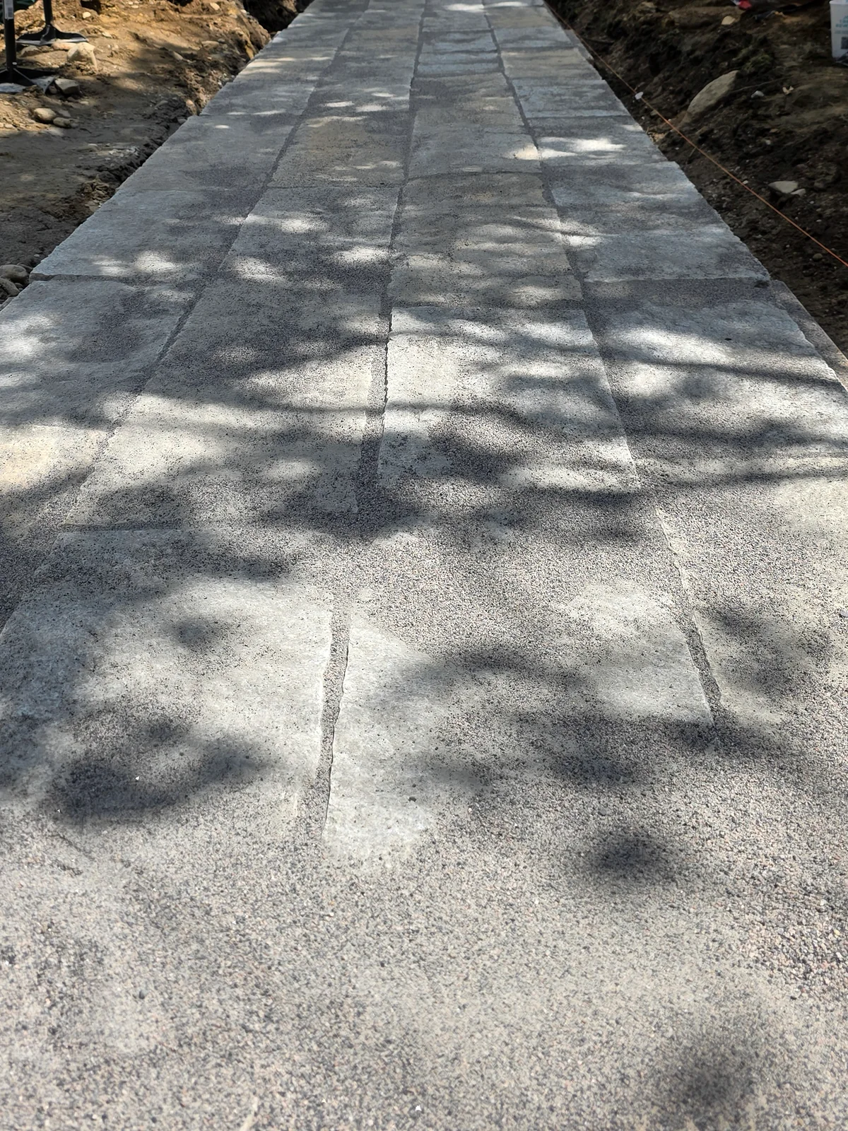 Laid walkway pavers with unfinished edges during construction